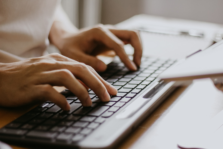 Male Hands Typing on a Wireless Computer Keyboard